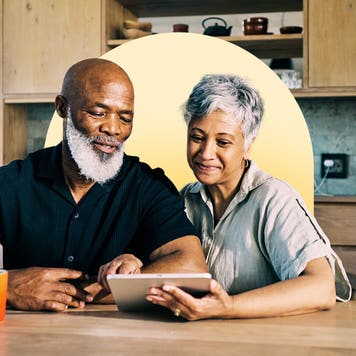Couple looking at a tablet.