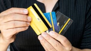 Man holding several credit cards and he is choosing a credit card to pay and spend Payment for goods via credit card