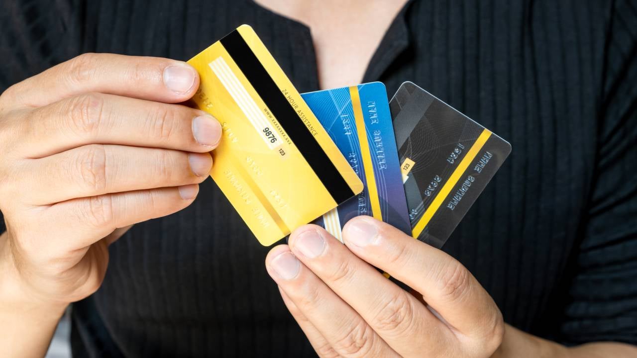 Man holding several credit cards and he is choosing a credit card to pay and spend Payment for goods via credit card