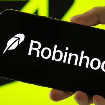 A person holds a smartphone displaying the logo of Robinhood Markets.