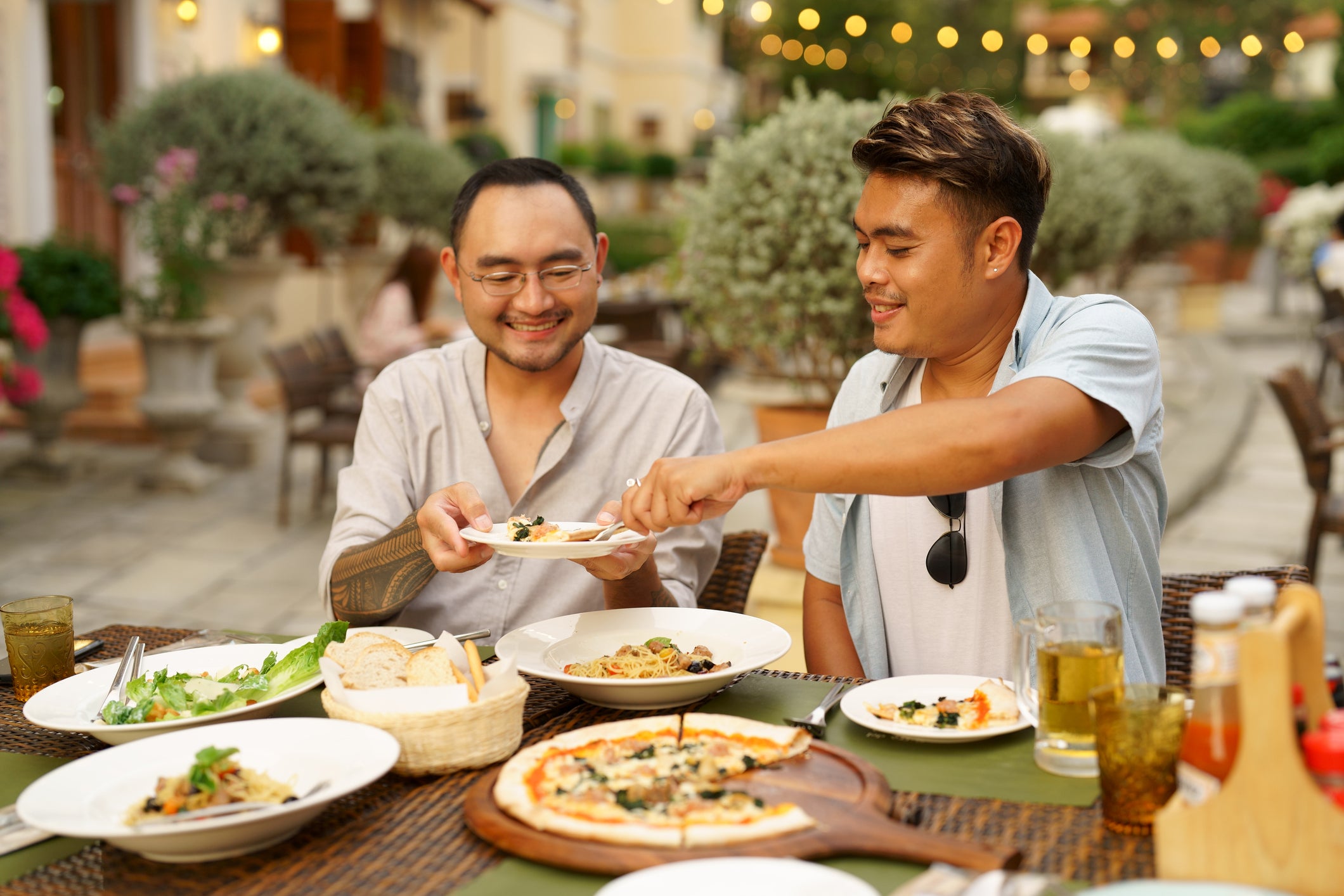 Happy men couple celebrating anniversary together outdoor dining during vacation, Outdoor dining, gay couple enjoy eating at the outdoor restaurants