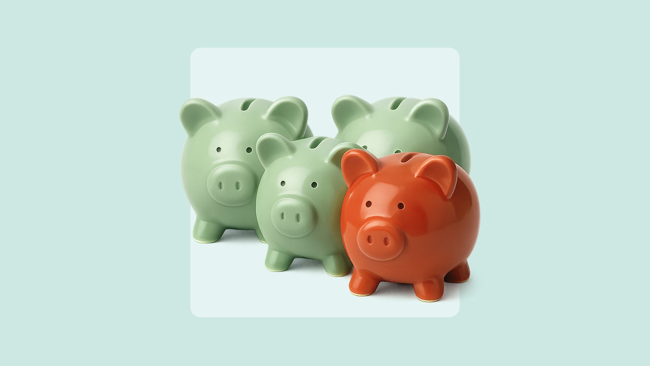 Image of four piggy banks of different sizes grouped together. Three are a light green color and the one in front is brick red.