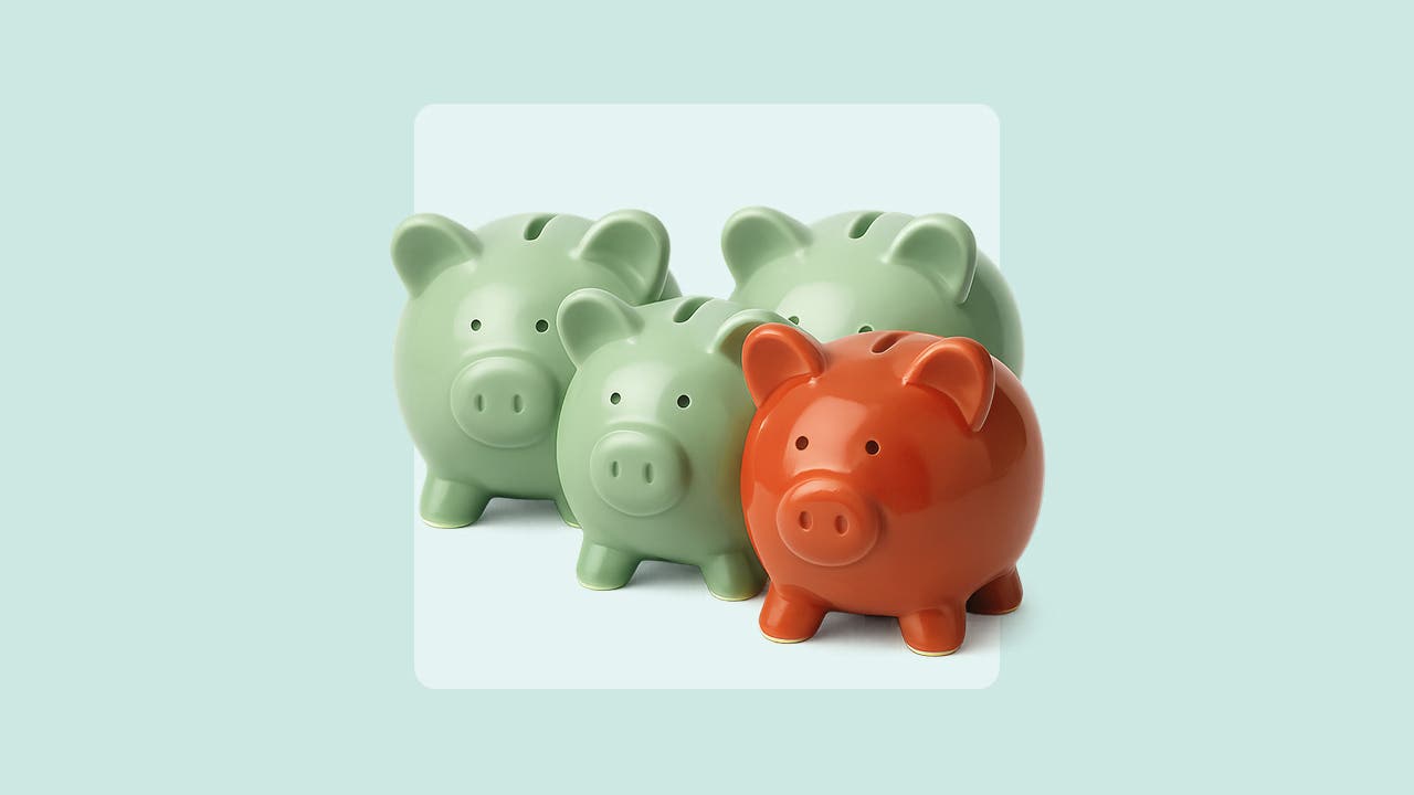 Image of four piggy banks of different sizes grouped together. Three are a light green color and the one in front is brick red.