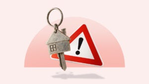 Key in the shape of a house over a triangular warning sign with an exclamation point all over a light red background
