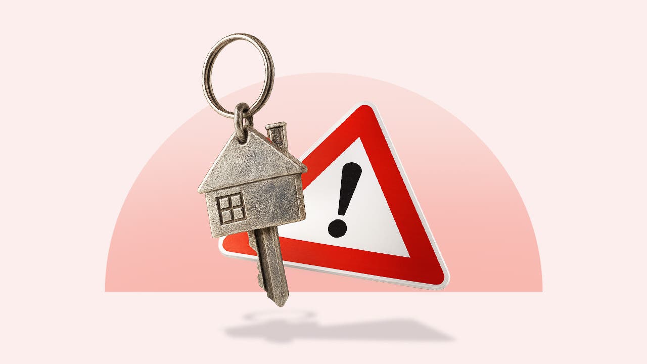 Key in the shape of a house over a triangular warning sign with an exclamation point all over a light red background