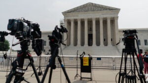 Video cameras point at an empty podium outside the US Supreme Court