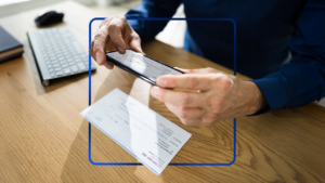 Photo of person taking photo of check with design element included