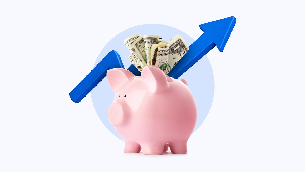 Image of a piggy bank stuffed with dollars and an arrow behind it pointing to the right and going up.