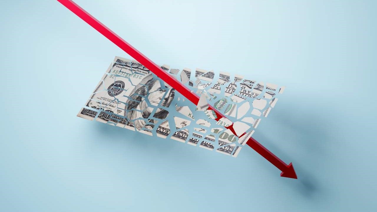 A downward facing red arrow "crashing" trough a shattering $100 bill.