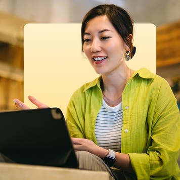 design image of a woman on her laptop smiling