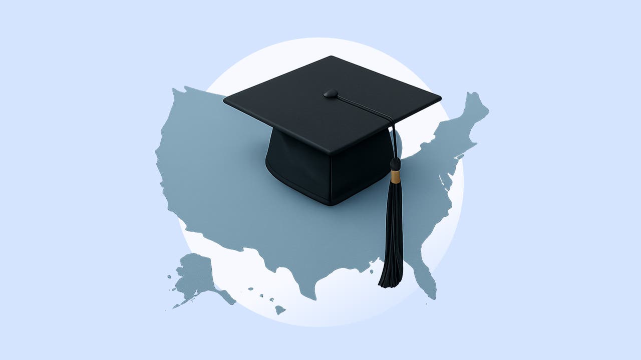 A graduation cap sitting on top of a plain map of the United States.