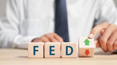 Fed rate hike to curb inflation, wooden block with FED and up-down arrows icon. Central banking system and interest rate changes.