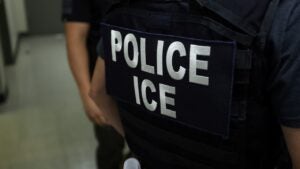 An agent of Immigration and Customs Enforcement (ICE) waits in a hallway outside of a courtroom at New York Federal Plaza Immigration Court inside the Jacob K. Javitz Federal Building in New York on July 17, 2025.