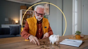 photo illustration: gray haired man with glasses thinking about retirement savings