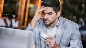 Young man having more expenses than expected.