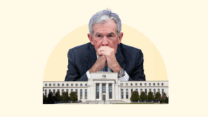 Fed Chair Jerome Powell is superimposed over the Fed Building, looking pensive