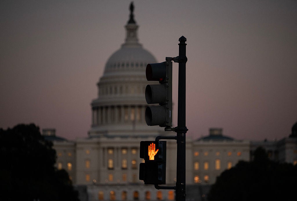 A crosswalk signal of a traffic light flashes backdropped by the US Capitol in Washington, DC, on October 1, 2025, the first day of the US federal government shutdown. Efforts to bring a quick end to the US government shutdown floundered Wednesday when senators rejected a plan to resolve an acrimonious funding stand-off between President Donald Trump and Democrats in Congress. With the government out of money after Trump and lawmakers failed to agree on a deal to keep the lights on, many federal departments and agencies have been closed since midnight.