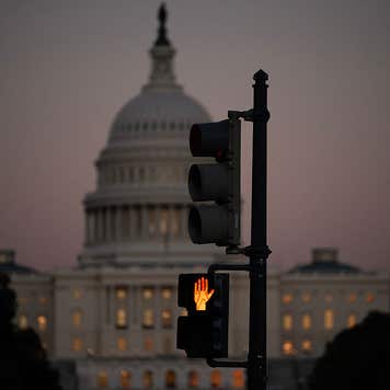 A crosswalk signal of a traffic light flashes backdropped by the US Capitol in Washington, DC, on October 1, 2025, the first day of the US federal government shutdown. Efforts to bring a quick end to the US government shutdown floundered Wednesday when senators rejected a plan to resolve an acrimonious funding stand-off between President Donald Trump and Democrats in Congress. With the government out of money after Trump and lawmakers failed to agree on a deal to keep the lights on, many federal departments and agencies have been closed since midnight.