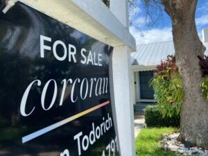 A close-up on a home for sale sign