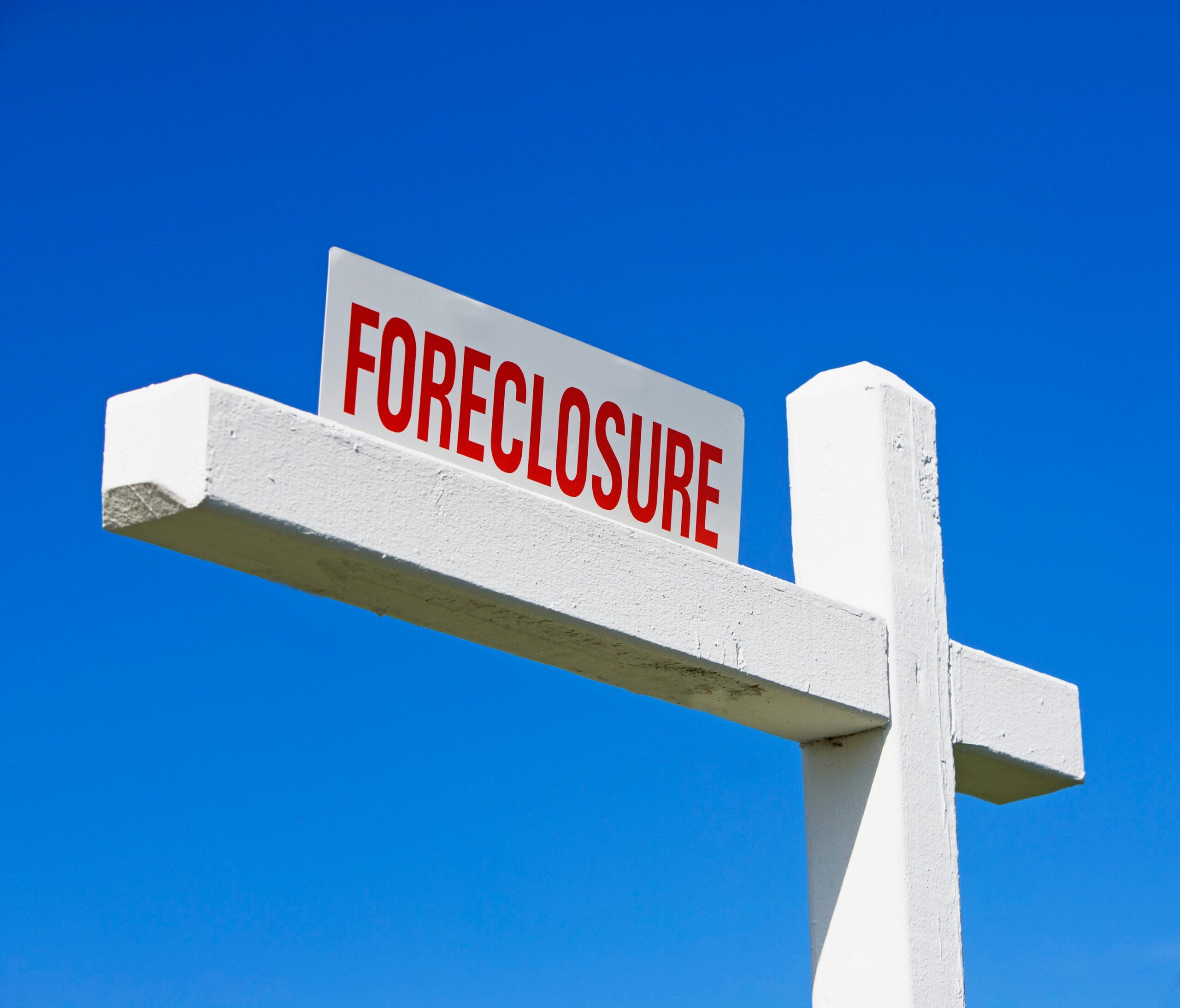 A Floreclosure sign against a blue sky backdrop.