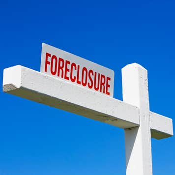 A Floreclosure sign against a blue sky backdrop.
