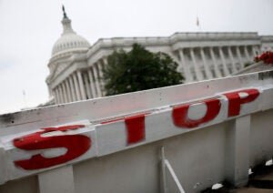 The US Capitol building is seen behind a barricade amidst the government shutdown