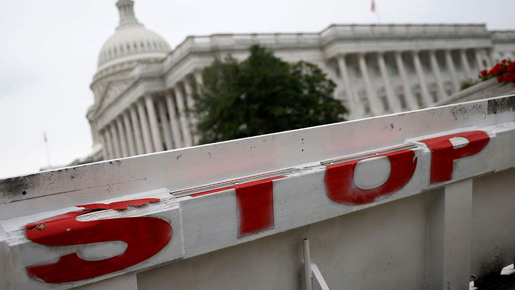 The US Capitol building is seen behind a barricade amidst the government shutdown