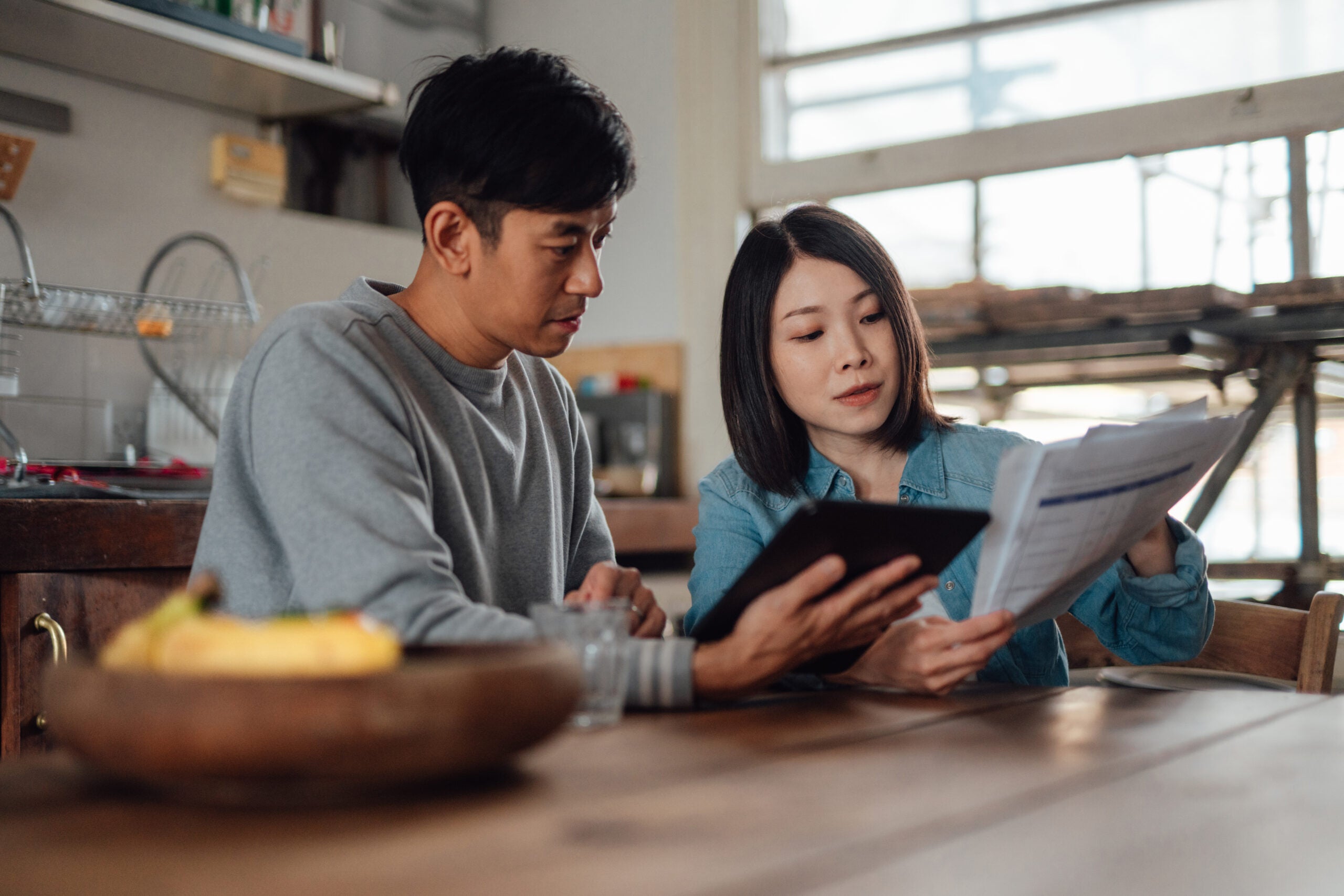 Couple looking over finances in their kitchen