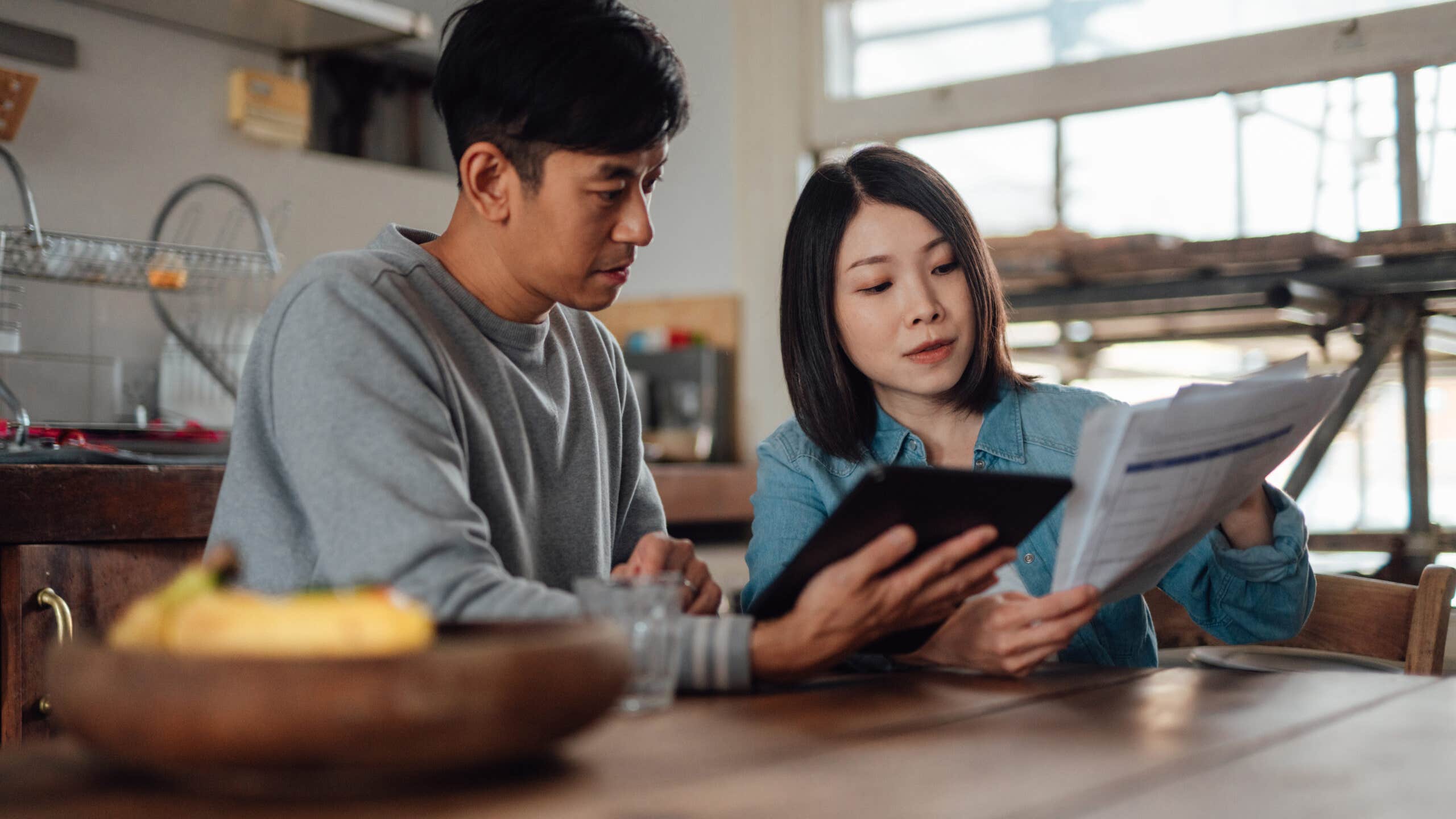 Couple looking over finances in their kitchen