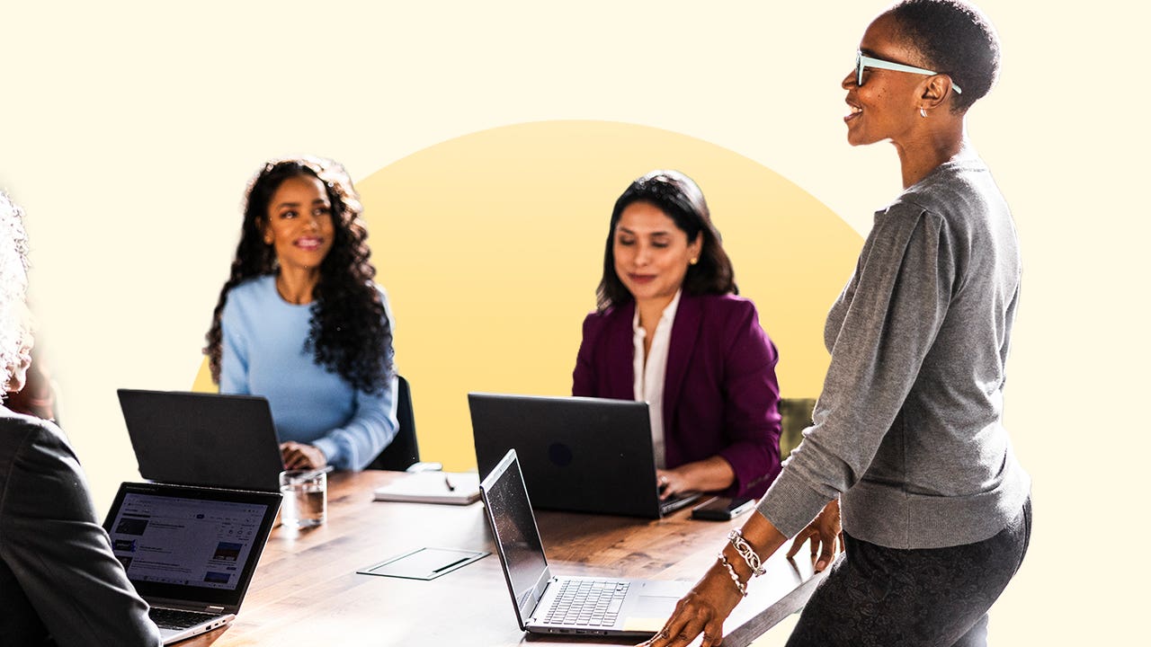 Working women gathered around a table at an office