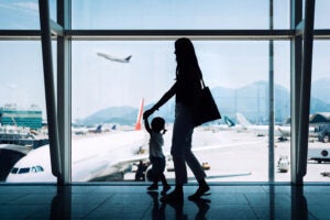 Silhouette of mother and daughter at an airport