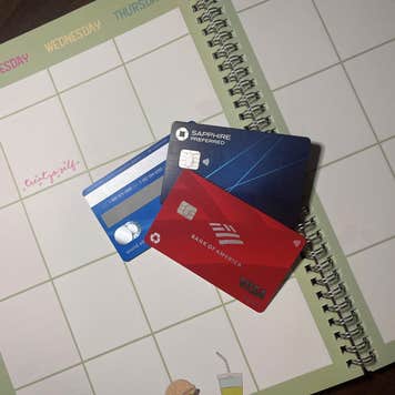 Three credit cards laying on an open planner