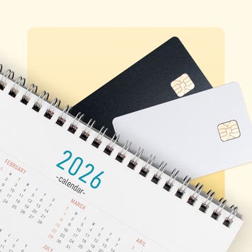 Credit cards lay with a 2026 calendar on a yellow background