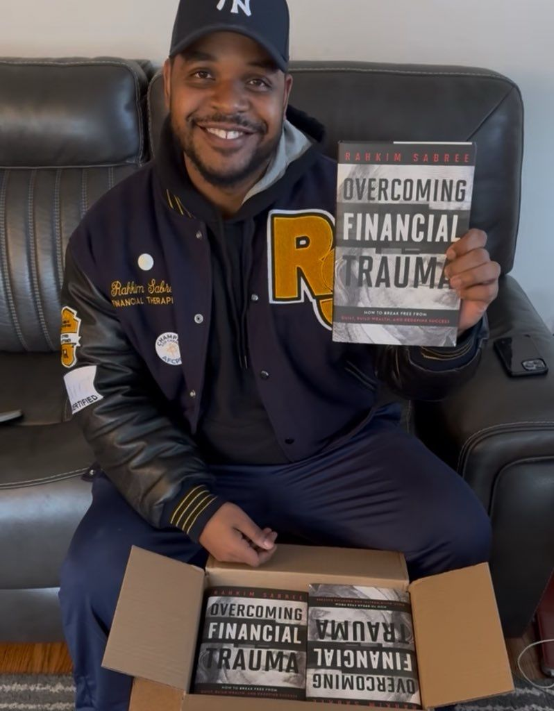 An image of Rahkim Sabree, AFC, holding a copy of his book on overcoming financial trauma