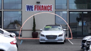 A dealership with a "We Finance" banner