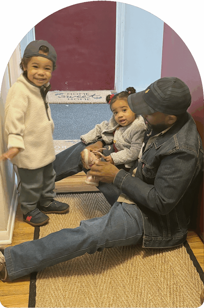 Jorge Javier puts on his kids' shoes.