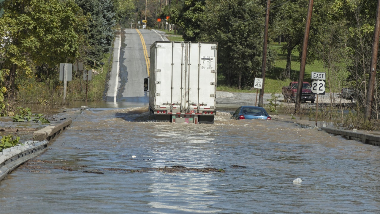truck and car stuck in flood