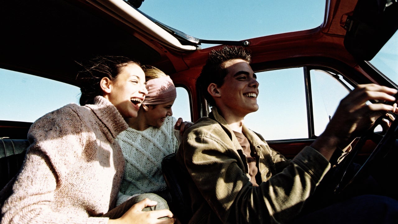 three teenagers in a car with open sunroof