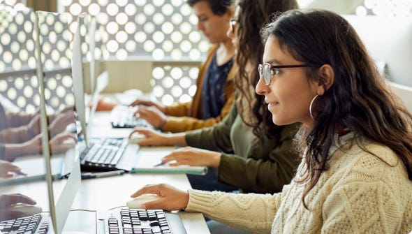 Girl with glasses using a computer and mouse